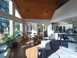 Open living/dining/kitchen all overlooking the lake through a wall of windows.