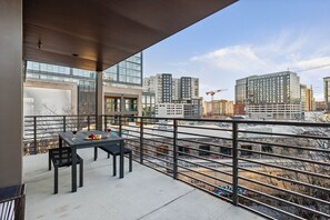 Private patio accessible from the living area adorned with outdoor seating where you can enjoy moments of serenity amidst the urban landscape.