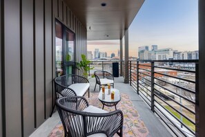 Private Corner Balcony offering outdoor furnishings for lounging and dining accompanied by the beautiful Nashville Cityscape.