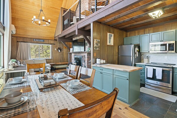 Main Level Living Room, Dining Room, and Kitchen with Balcony from Upper Level overlooking.