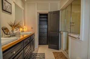 "Unwind in this stylish bathroom featuring a double vanity and a spacious shower."