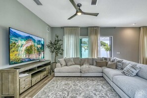 Relax in our spacious living room, featuring an expansive couch and an 85" TV for ultimate entertainment
