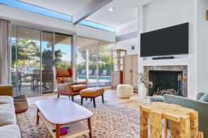 Spacious and modern living room with huge flat screen 4k tv.