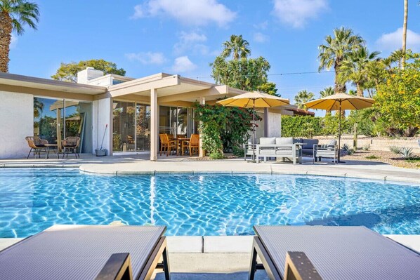 Gorgeous view of the amazing pool and mid century home!