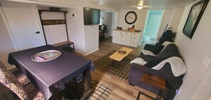 Guest area, kitchette, couch, bar fridge/freezer, dining table and TV