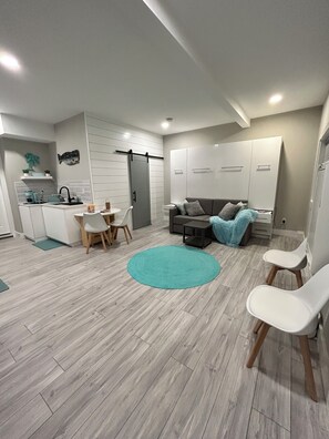 Open concept living space with full kitchen and small dining area. 