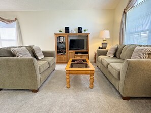 Cozy entertainment area with ample seating and a large TV for movie nights.