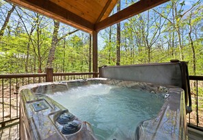 A hot tub enclosed within a covered deck area