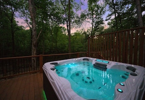 Relax among the treetops. Our hot tub overlooks nature, making every soak a serene escape.