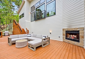 Outdoor bliss awaits! Lounge by the fire on our spacious deck, where comfort meets the great outdoors.