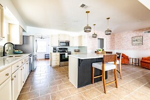 Large, open kitchen with all the essentials provided + seating options