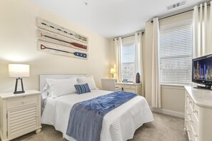 The 2nd bedroom features a nautical theme with a full bed and a desk to study or get some work done.