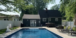 Swim in relax in the peaceful backyard with a pool and hot tub.