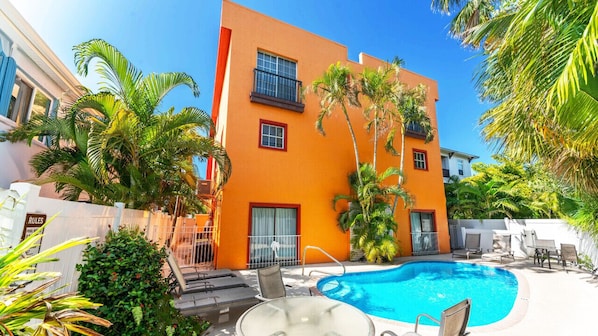 Rear of fourplex, pool and backyard for guests only