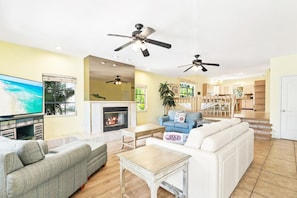 Living room with ceiling fans and fireplace