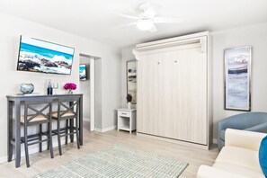 Living room with Murphy Queen Bed & HDTV