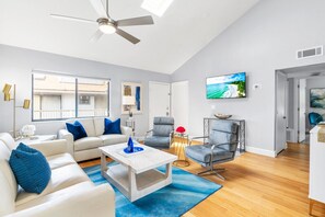 Living room, with ceiling fan, a/c, and HDTV