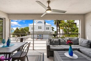 Partial ocean views, ceiling fan, outdoor couch and dining area