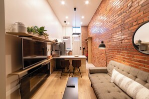 Living room area with TV and fireplace for ambiance.