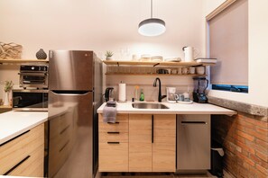 More than a kitchenette... this Kitchen provides fridge, dishwasher, microwave, infrared cook top, and Cuisinart air fryer, toaster, oven that can cook a 12" pizza.