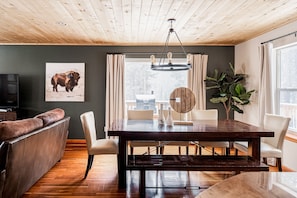 Ample seating in open concept kitchen/dining/living area. Deck access with views