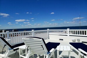 Rooftop deck with comfortable lounge chairs and side tables