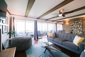 A wall of glass brings sunlight into the living room