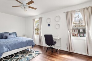 Enjoy the luxurious primary bedroom featuring an ensuite full bathroom, ceiling fan, Roku Smart TV, abundant natural light, and a dedicated workspace complete with an ergonomic chair.