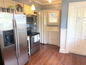 Part of kitchen includes washer/dryer.