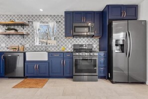 Full kitchen with dishwasher, microwave, gas stove/oven, and refrigerator.