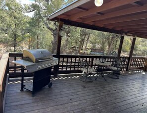 Spacious front porch with seating and grill