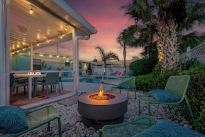 Cozy up by the firepit at sunset for an unforgettable evening.