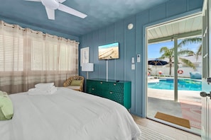 The in-law suite offers an ultra-comfortable hybrid king bed, an ensuite bathroom, a Smart TV, and direct access to the poolside area.