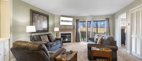 Living Room with Fireplace, TV & Patio Access