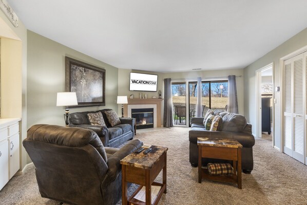 Living Room with Fireplace, TV & Patio Access