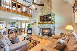 This is the main living room boasting vaulted ceilings, comfy seating, and a gas fireplace. 