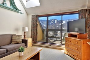 Kick back in our cozy living room, tune into your favorite TV show and soak up our stunning mountain views. Perfect for your chill-out days on vacation!