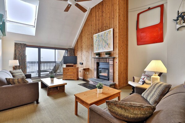 2-bedroom, 2-bathroom loft condo in the scenic Mountain Green Resort in Killington, Vermont. Kick back in our cozy living room with rustic wood accents and a warm, inviting fireplace. It's the perfect spot to unwind after your day of adventures.