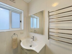 Stylish bathroom with shower, vanity and toilet