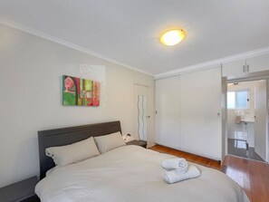 Bedroom with built in robes and access to the modern bathroom