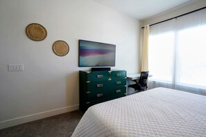 Guest Master Suite with a 55 inch TV,  sonos surround sound and a 47” Motorized Adjustable Height Desk.