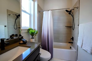 Guest Master Suite | Ensuite Bathroom featuring a tub, shower and a bidet.