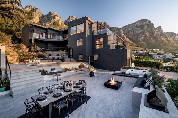 Large entertainment area with pool, jacuzzi, fire pit, dining area and gas BBQ