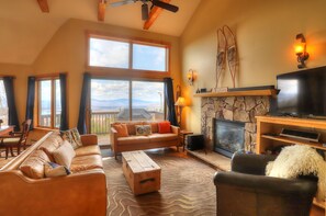Living room with sliders to deck - gorgeous mountain and lake views!