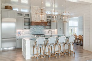 Modern kitchen with an island and barstool seating.