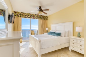 Primary bedroom features a king bed, TV, balcony access, and an ensuite bathroom.