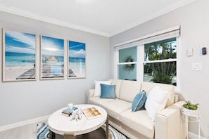 Living room, view of front lanai and yard