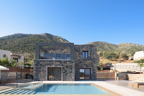 A fusion of wood, glass and poured concrete combine at this luxury home.  
