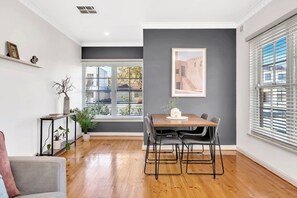 A spacious dining area offers a four seater table where everyone can easily enjoy a meal at home.