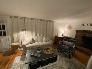 Shiplap living room with desk, full sleeper sofa, Roku TV